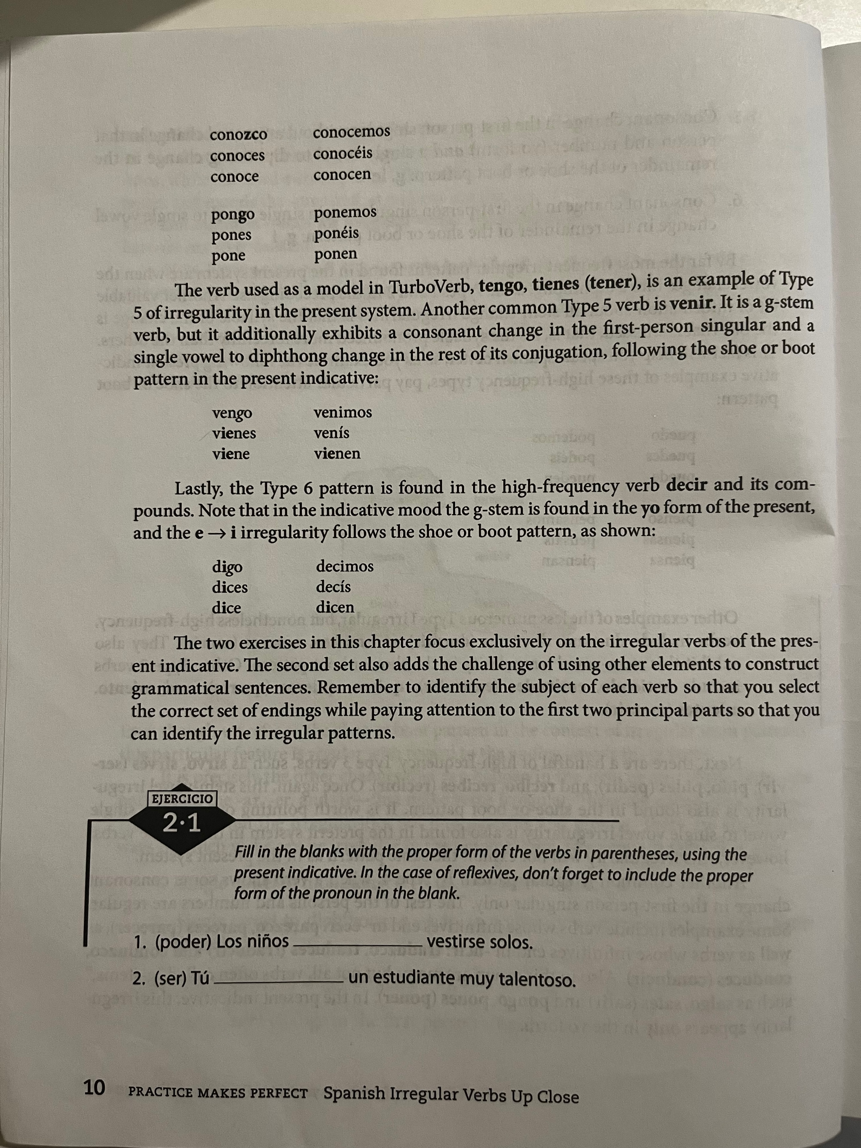 Cristina explaining Spanish irregular verbs conjugation on a worksheet